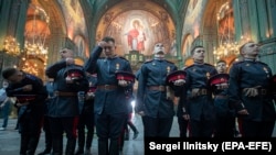 Russian soldiers attend a service in the Cathedral of Christ's Resurrection in Patriot Park, outside Moscow.