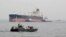 IRAN -- An Iranian military speedboat patrols the waters as a tanker prepares to dock at the oil facility in the Khark Island, March 12, 2017