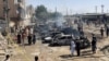 People and police officers gather after a blast near a railway track in Quetta, the regional capital of Baluchistan in Pakistan, on May 24.