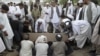 Mourners bury Kandahar City Mayor Ghulam Haidar Hamidi, one of the region's most trusted public servants, who was assassinated last month. 