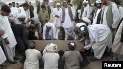 Mourners bury Kandahar City Mayor Ghulam Haidar Hamidi, one of the region's most trusted public servants, who was assassinated last month. 