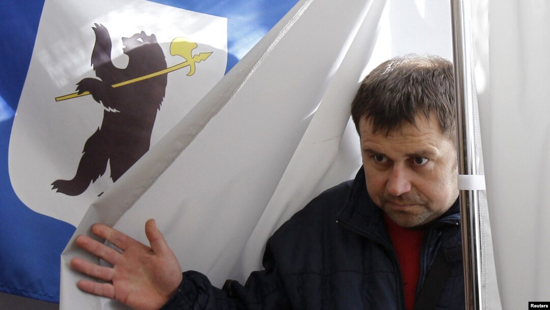 A man leaves a voting booth during the mayoral election in the city of Yaroslavl on April 1.