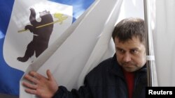 A man leaves a voting booth during the mayoral election in the city of Yaroslavl on April 1.