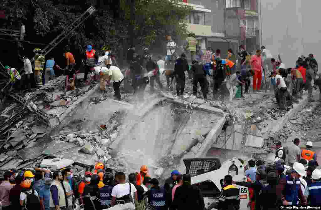 MEXICO -- Soldiers, rescuers and people work at a collapsed building after an earthquake in Mexico City, Mexico September 19, 2017