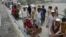 An Afghan man pushes a cart with a woman and children as they cross the border between Afghanistan and Pakistan in the Torkham area of Nangarhar Province on September 15.