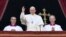 Pope Francis (center) waves from the balcony of St Peter's Basilica in the Vatican during the traditional "Urbi et Orbi" Christmas message to the city and the world on December 25.