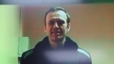 FILE PHOTO: Russian opposition leader Alexei Navalny is seen on a screen via video link during a court hearing in Moscow