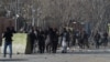 Afghan volunteers and policemen help the wounded at the scene of a car bomb attack in front of the old Interior Ministry building in Kabul on January 27. 