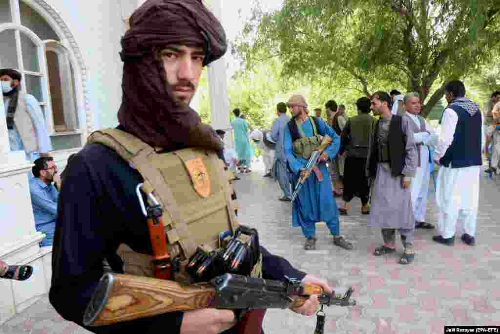 Armed supporters of former mujahedin commander Ismail Khan guard his residence on July 9. Khan and his followers have vowed to fight alongside Afghan security forces against the Taliban as the militants advance into the western Herat Province.&nbsp;