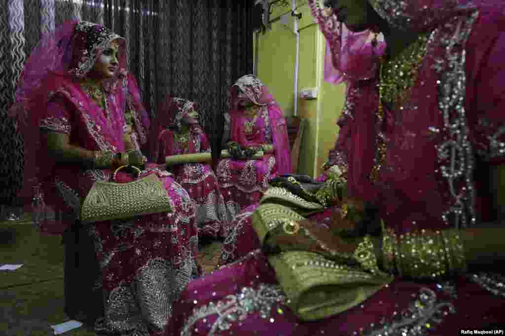 Indian Muslim brides chat as they wait backstage before a mass wedding event in Mumbai. (AP/Rafiq Maqbool)