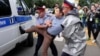 Kazakh police detain a demonstrator in Almaty on June 12.