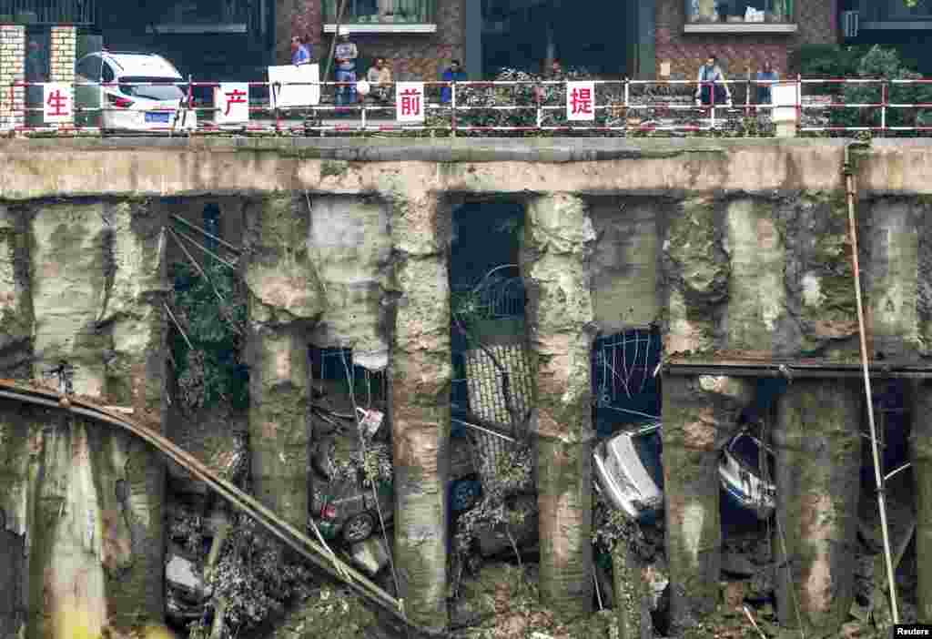 Cars are seen in a sunken open-air parking lot after heavy rainfall hit Chengdu, in China&#39;s Sichuan Province, on July 9. (Reuters/China Daily)