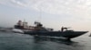 A speedboat of the Iran's Revolutionary Guard moves around a British-flagged oil tanker Stena Impero, which was seized on Friday by the Guard, in the Iranian port of Bandar Abbas, July 21, 2019