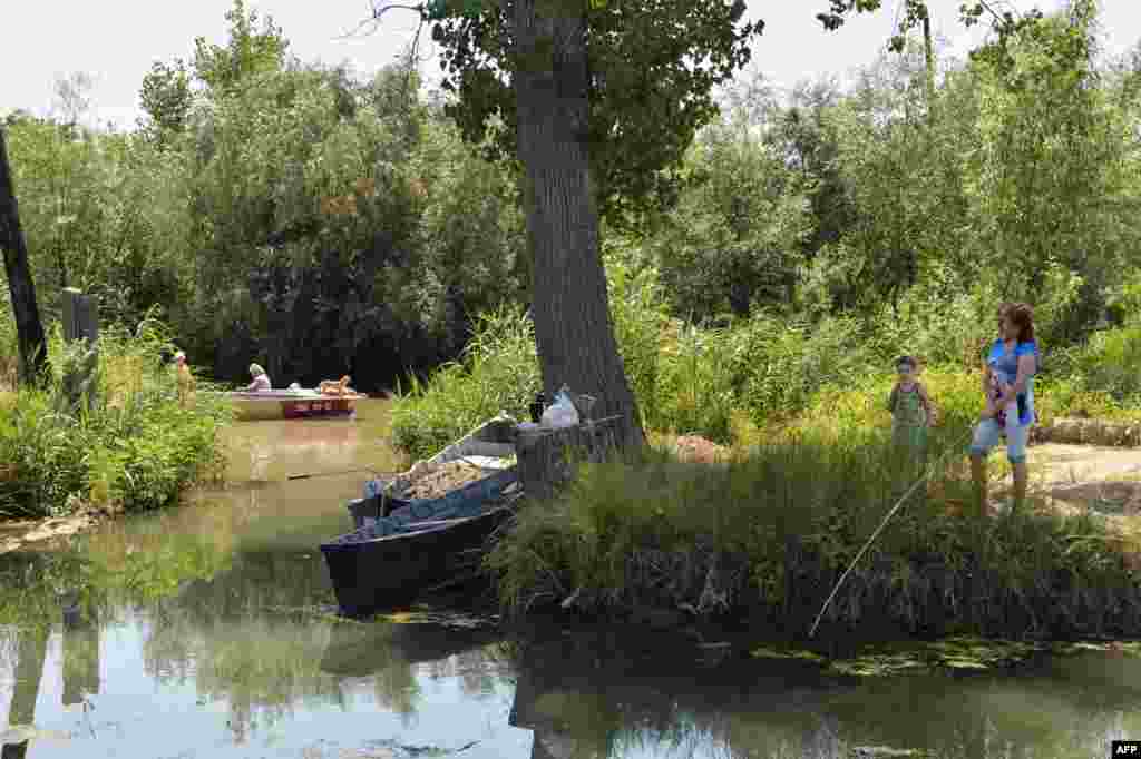 Fishing from the riverbank. The Danube River and the delta region are home to a wide variety of fish and bird species. 