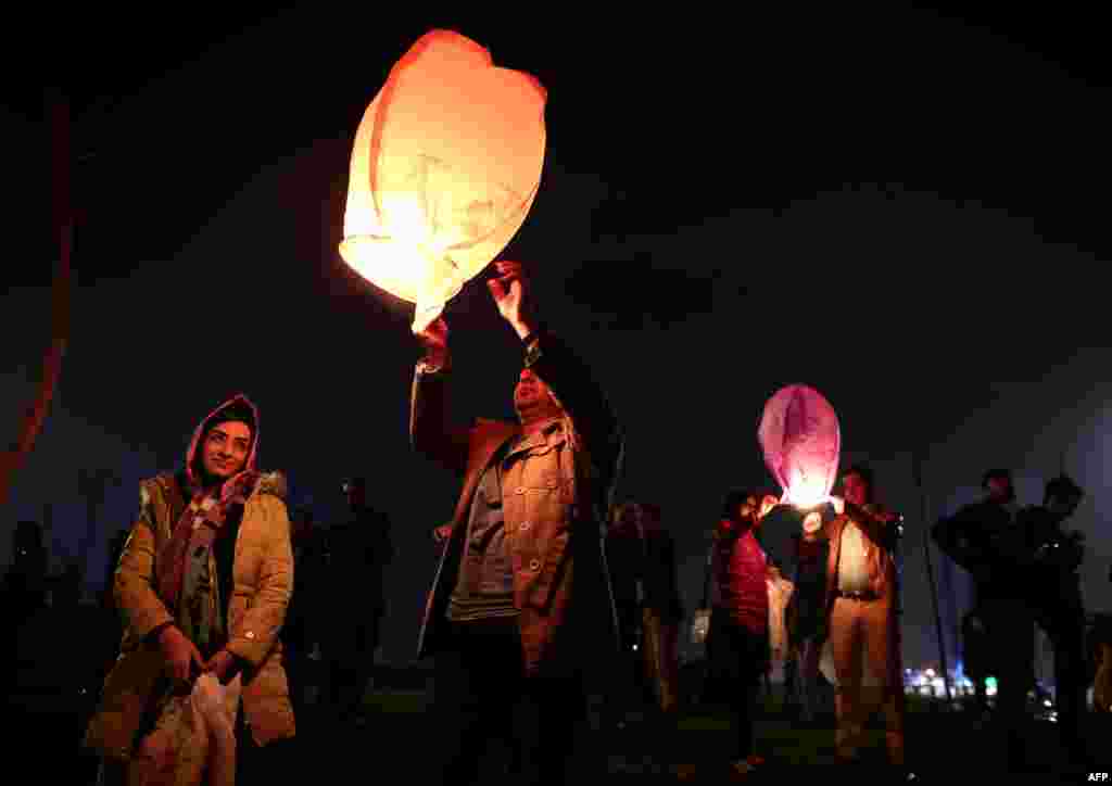 Iranian families release lanterns in a park in Tehran on March 17. (AFP/Behrouz Mehri)