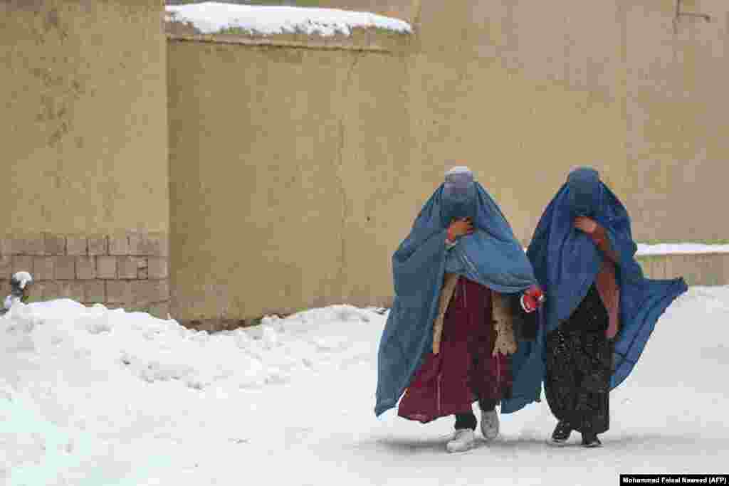 After: Burqa-clad women walk along a snowy street in January 2026.In August 2024 the Taliban imposed a "morality law" that placed severe restrictions on women, including a requirement to cover their faces when in public.
