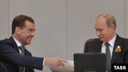 Russian President Vladimir Putin (right) with Dmitry Medvedev at a special session of the State Duma in Moscow, which confirmed the latter's appointment as prime minister. 