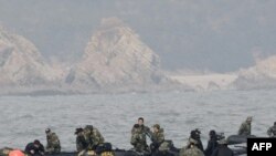 South Korean navy personnel search for survivors and bodies from the sunken "Cheonan" near the border with North Korea in late March.