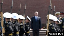 Russian President Vladimir Putin attends a ceremony in memory of those killed during World War II a the Tomb of Unknown Soldier in Moscow on June 22. 