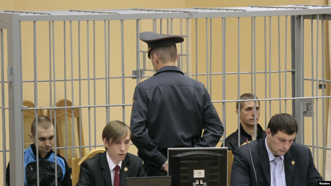 Convicted killers Dzmitry Kanavalau (far left) and Uladzislau Kavalyou (second from right) sit in the dock during court hearings in Minsk in September.