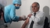 Samariddin Alizoda, Tajikistan's former deputy health minister, receives a COVID-19 vaccine. (file photo)