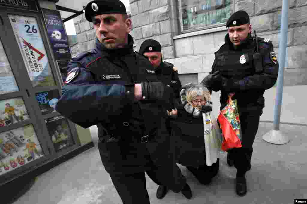 Russian police detain a protester against Russian President Vladimir Putin after she took part in a lone picket in central Moscow. (Reuters/Maxim Zmeyev) 