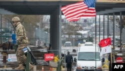 A U.S. flag blows over a tank in front of an Estonian-Russian border point during a military parade to celebrate 97 years since first achieving independence in 1918 in Narva in February.