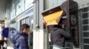 File photo:Iranians withdraw money from an ATM machine at a Bank Sepah in the capital Tehran on January 19, 2016. (Photo by ATTA KENARE / AFP)