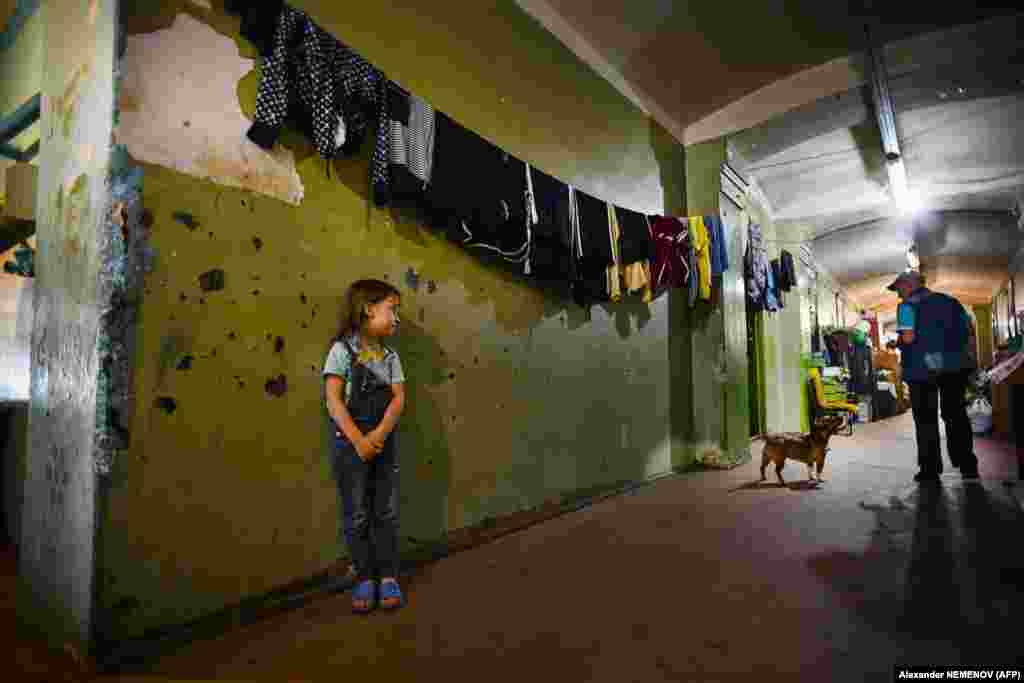 A girl stands in a communal corridor.&nbsp;While the Proletarka stands out for its crumbling grandeur, the living conditions are nothing unusual in Russia, where many still live in long-unrenovated buildings due for demolition.