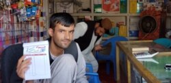 Said Wali, the owner of Hewad Internet Café provides satellite Internet in Tarinkot.