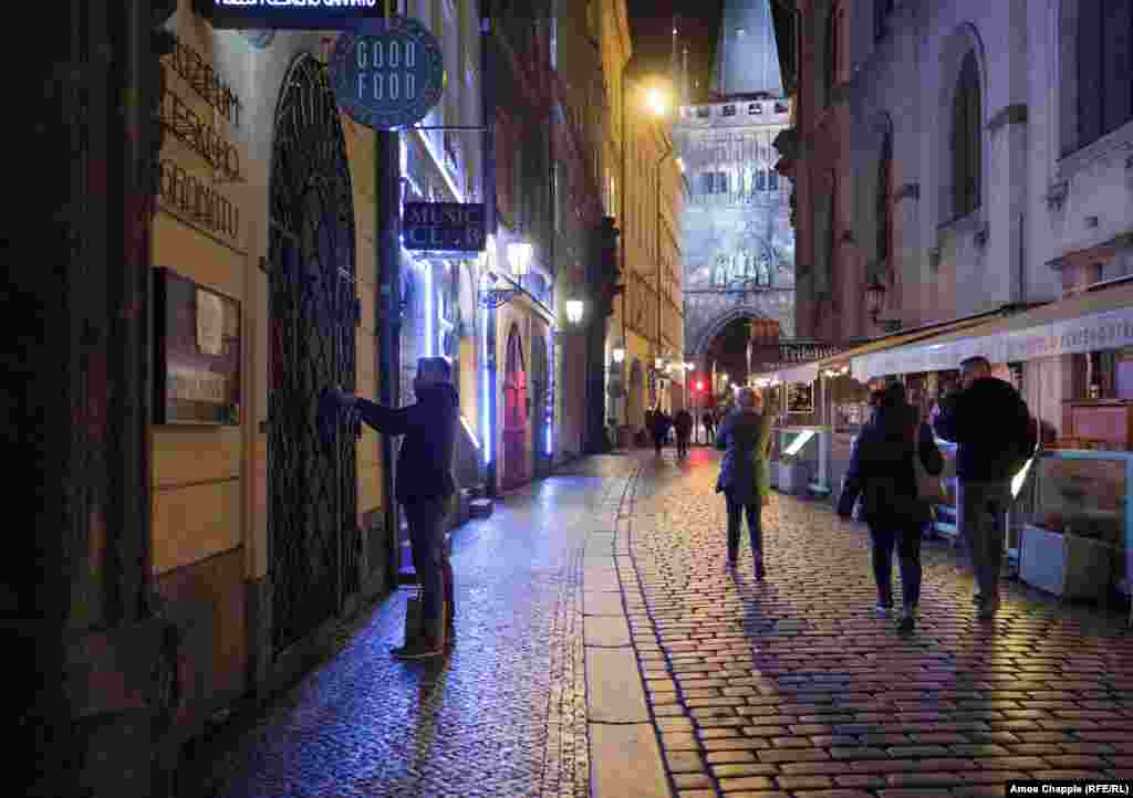 A man closes his restaurant shortly after 8 p.m. in Prague&#39;s Old Town.&nbsp;