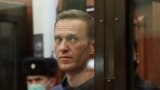 A still image taken from video footage shows Russian opposition leader Alexei Navalny, who is accused of flouting the terms of a suspended sentence for embezzlement, inside a defendant dock during the announcement of a court verdict in Moscow