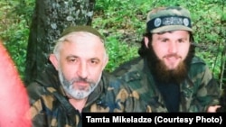 In this undated photo, Zelimkhan Khangoshvili (right) is shown seated alongside Aslan Maskhadov (left), who served briefly as president of Chechnya in the 1990s. (file photo)