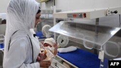 Pakistan -- A doctor places a new born baby into an incubator at the Lady Aitchison hospital in Lahore, 31Oct2011