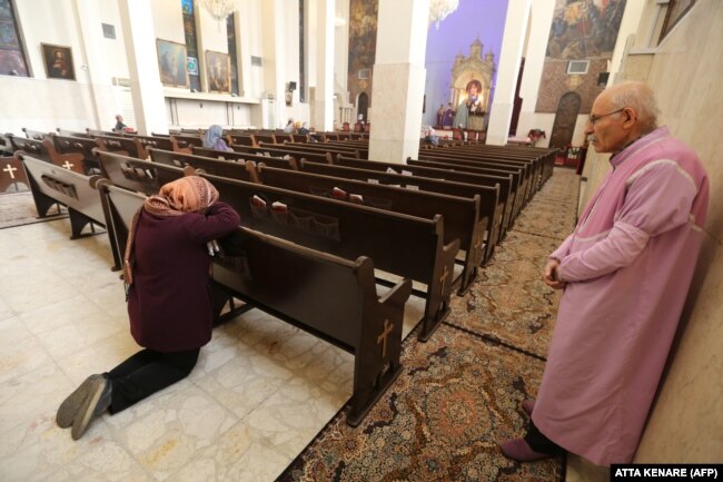 Iranian Christians pray during New Year's Mass at the St. Sarkis Armenian Cathedral in Tehran on January 1, 2020.