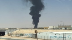 A large plume of smoke rises from the fuel  depot at King Khalid International Airport in Riyadh on September 19.