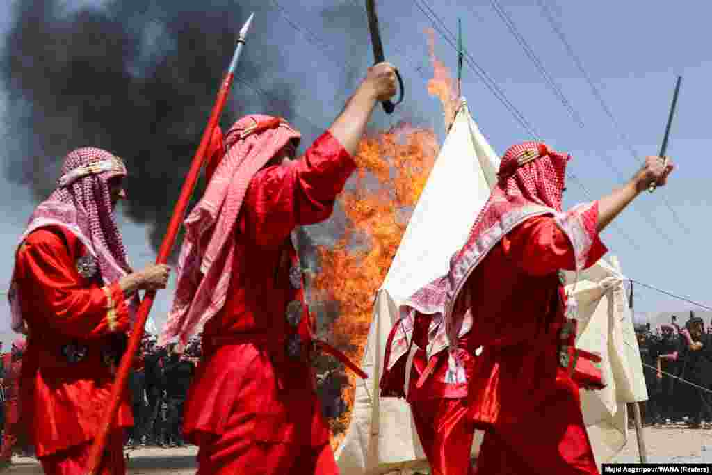 Iranians burn a tent as part of a reenactment of a scene from the seventh-century battle of Karbala during a ceremony to mark Ashura, the holiest day on the Shi&#39;ite Muslim calendar, in Tehran on August 8.