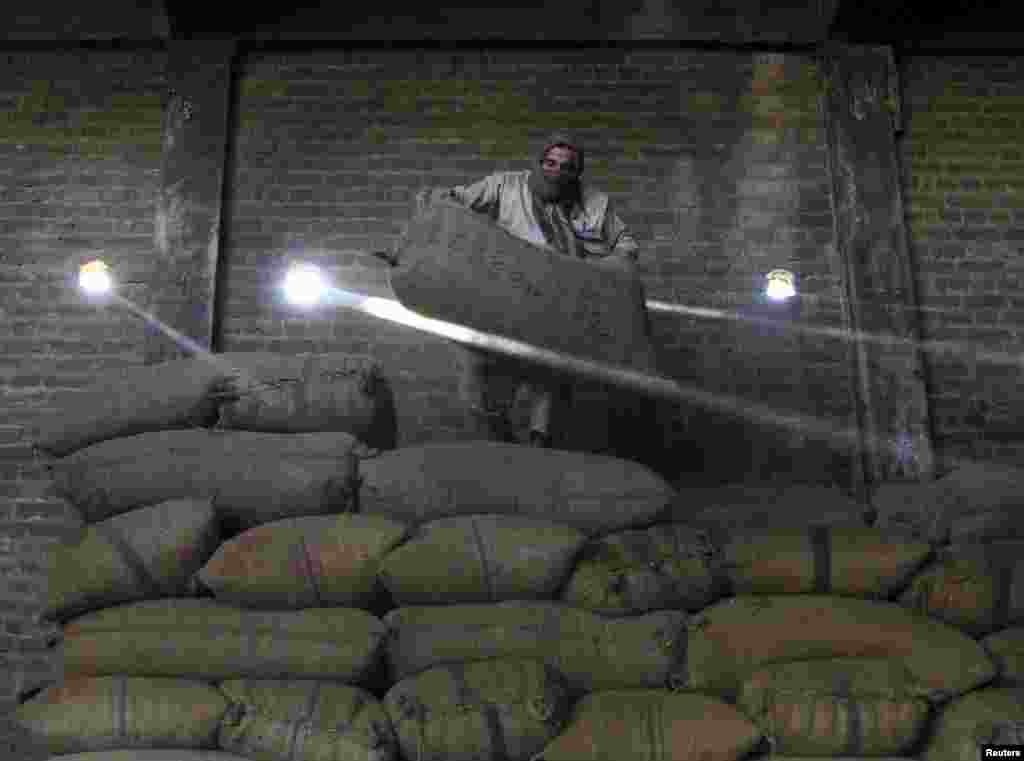 An Afghan man works at a dry fruit factory in Jalalabad on August 25. (Reuters/Parwiz)