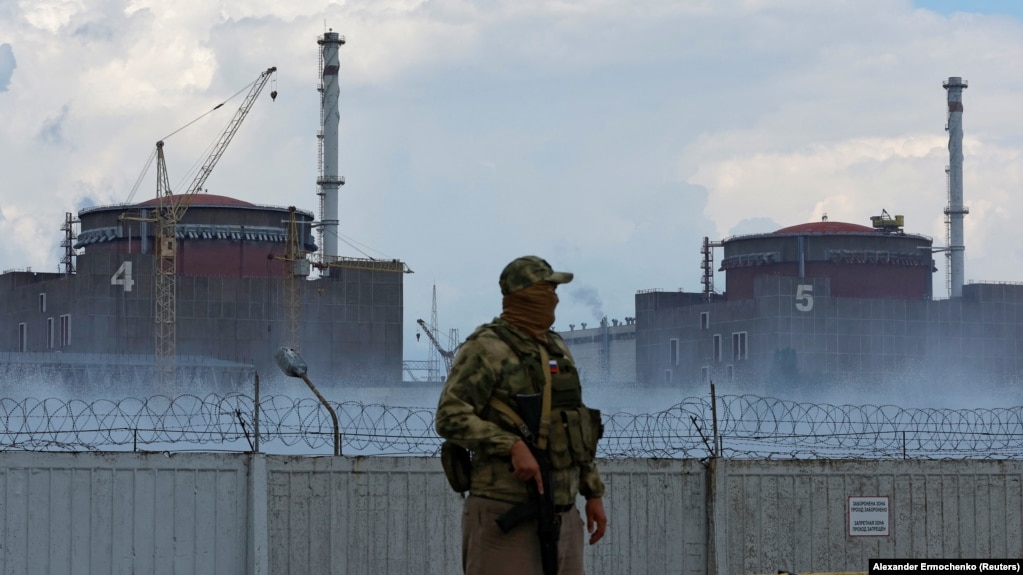 A soldier with a Russian flag on his uniform stands guard near the Zaporizhzhya nuclear power plant on August 4.