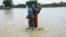 A Pakistani soldier rescues a child from the flood-affected Rajanpur district in Punjab Province on August 2. 