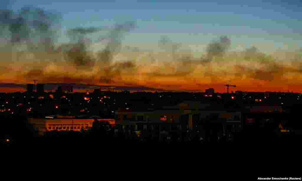 Smoke rises above buildings during sunset in the course of Russian&#39;s invasion of Ukraine in Donetsk in eastern Ukraine.