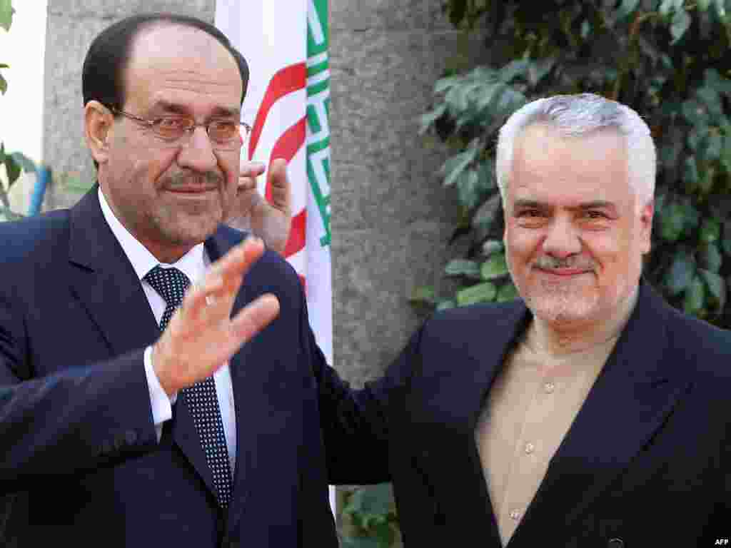 Iran -- First Vice President Mohammad Reza Rahimi (R) welcomes Iraqi Prime Minister Nuri al-Maliki to Tehran, 18Oct2010 - IRAN, Tehran : Iran's First Vice President Mohammad Reza Rahimi (R) welcomes on October 18, 2010 in Tehran Iraqi Prime Minister Nuri al-Maliki who is on an official visit to the Islamic republic to garner support for his premiership bid, as his chief rival Iyad Allawi accused Iran of meddling in Baghdad's political affairs. AFP PHOTO/ATTA KENARE 