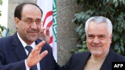 Iran's First Vice President Mohammad Reza Rahimi (right) welcomes Iraqi Prime Minister Nuri al-Maliki to Tehran.
