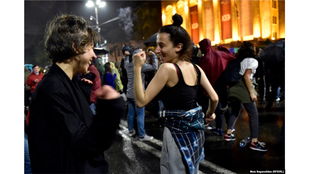Protesters dance in front of the Georgian parliament in Tbilisi on the night of May 13.