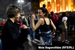 Protesters dance in front of the Georgian parliament in Tbilisi on the night of May 13.