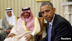 U.S. President Barack Obama (right) meets with Saudi Crown Prince Muhammad bin Nayef (center) in the Oval Office of the White House in Washington on May 13.