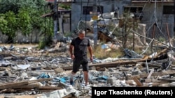Muškarac hoda među ruševinama stambenih zgrada uništenih ruskim raketnim udarom u naselju Zatoka u ukrajinskoj oblasti Odesa 26. jula.