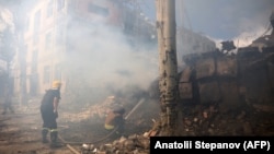 Firefighters extinguish a fire at a damaged school building following shelling in the town of Kramatorsk on July 21.