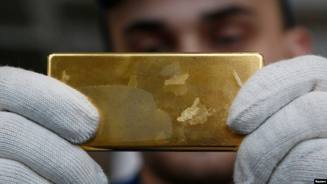 An employee shows a gold bar at a plant in Kasimov, Russia.