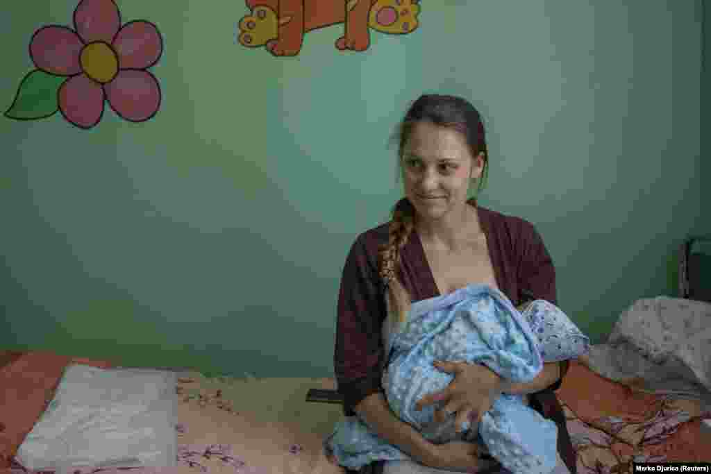 Iryna Budakova, 24, holds her as-yet unnamed 2-day-old boy.